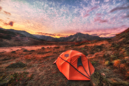 Orange tent in the mountains. Colorful sunriseの写真素材