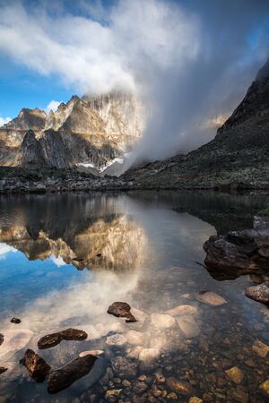 Beautiful landscape with lake and mountain. Stormy skyの写真素材