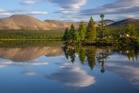 Beautiful landscape morning sunrise over stream and pine tree camping in lakeの写真素材