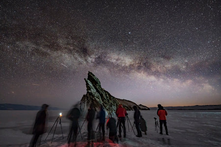 Silhouette of a group of photographers shooting Milky Way starsの写真素材