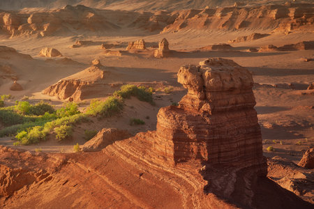 Stunning Desert Landscape with Rock Formations and Green Flora Oasisの写真素材