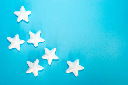 New Year's white fluffy stars lie on a blue background. Place for text. New Year card. Advertising spaceの写真素材