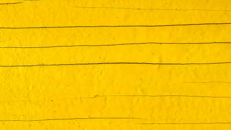 Yellow wooden background. A wooden old yellow board. Texture of painted wood in yellow for advertising and photoの写真素材