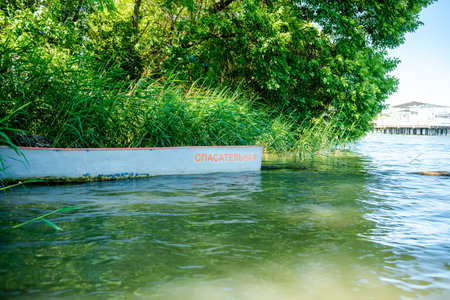 Boat on the lake with a warning signの写真素材