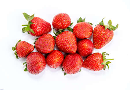 Bright red strawberry with green petals isolated on white backgroundの写真素材