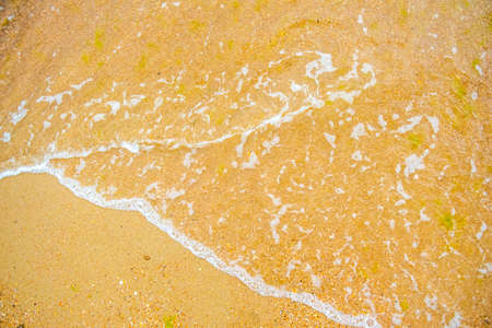 White wave on empty yellow sandy beach, summer or tropical climate background, nature background, daylight outdoorsの写真素材