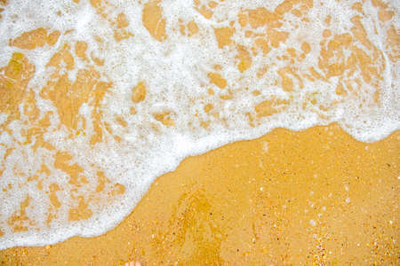 White wave on empty yellow sandy beach, summer or tropical climate background, nature background, daylight outdoorsの写真素材