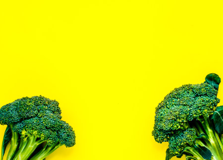 Juicy greens and broccoli on a yellow background. place for inscriptionの写真素材