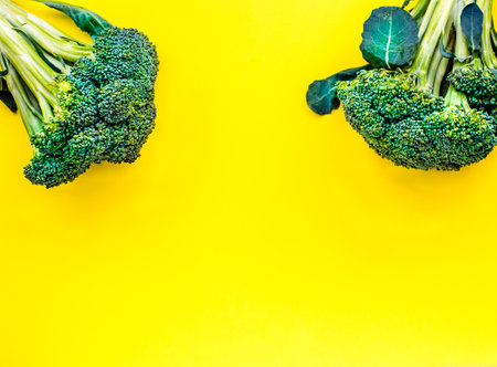 Juicy greens and broccoli on a yellow background. place for inscriptionの写真素材