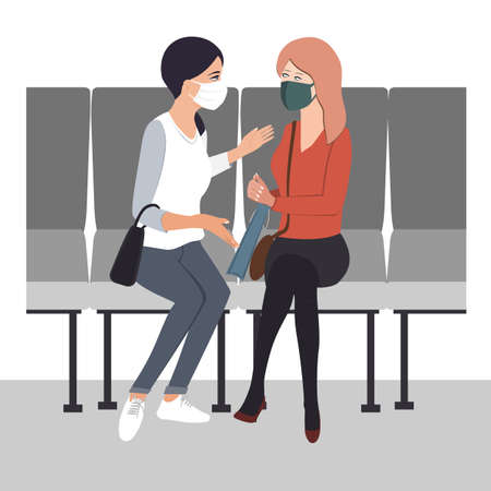 Two young women friends communicate with protective masks on their faces. Flat vector illustrationのイラスト素材
