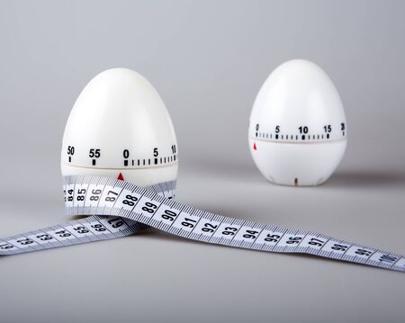 and two timers centimeter on a gray background in the kitchenの写真素材