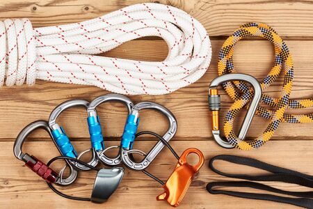 Climbing equipment on wooden background