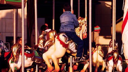 Kid on the horse on carousel, fair in Moscowの写真素材