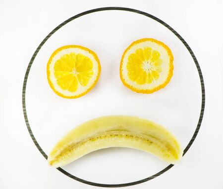 Fruit in the form of a sad faceの写真素材