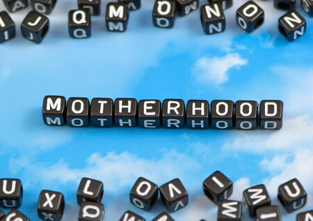 The word Motherhood on the sky backgroundの写真素材