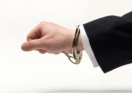 Handcuffs on the official hand over bribesの写真素材