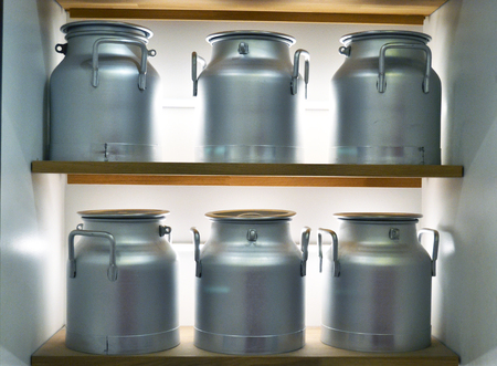 Aluminum milk cans on the shelvesの写真素材