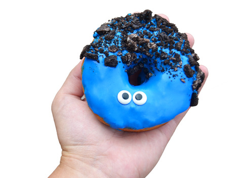 A beautiful donut lies on his handの写真素材