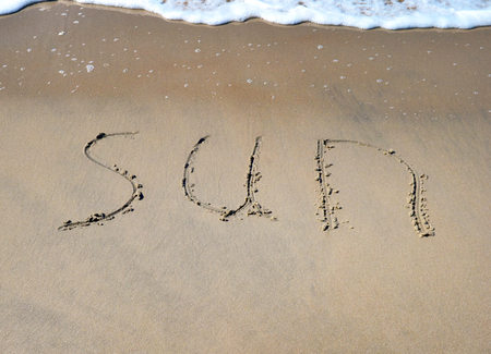 The word sun on the beach backgroundの写真素材