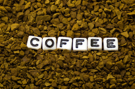 The word coffee on the background of instant coffeeの写真素材