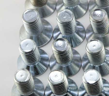 Machine-building screws closeup on white backgroundの写真素材