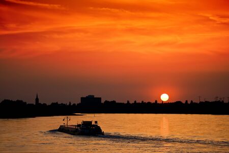 Barge with cargo at sunsetの写真素材