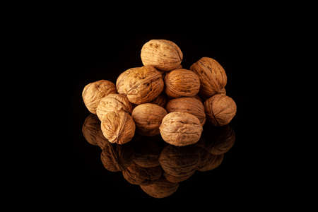 walnuts on black surface with reflectionの写真素材