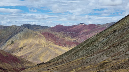 View of mountain range under a partly cloudy sky.