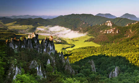 Beautiful summer landscape with village at sunriseの写真素材
