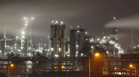 Petrochemical plant in night with smokestackの写真素材