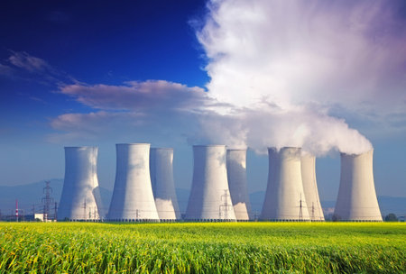 Nuclear  plant with yellow field and big blue cloudsのeditorial素材