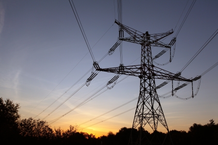 Electricity pylon at orange sunsetの写真素材
