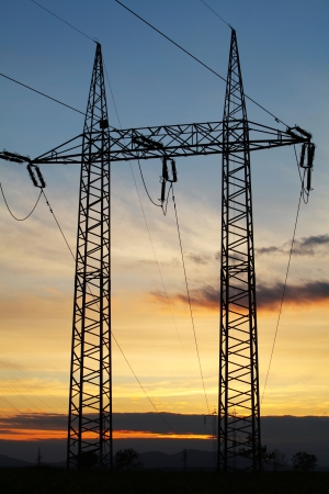 Electricity pylon on sunset - power energyの写真素材