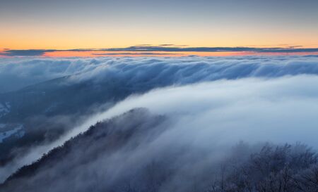 Winter sunset over the cloudsの写真素材