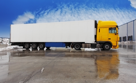 Yellow truck standing  on a parkingの写真素材