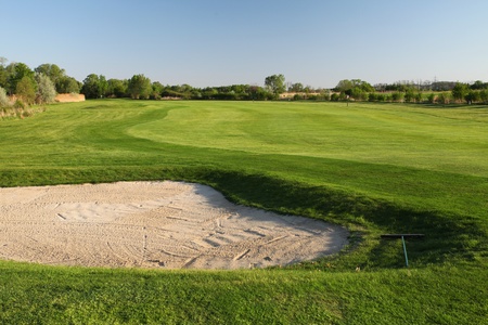 Beautiful golf place with gorgeous green and lakeの写真素材