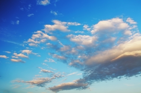 A deep blue sky with fluffy white cloudsの写真素材