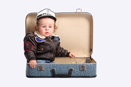Little boy with suitcase over whiteの写真素材