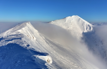 Winter mountain landscape with sunの写真素材