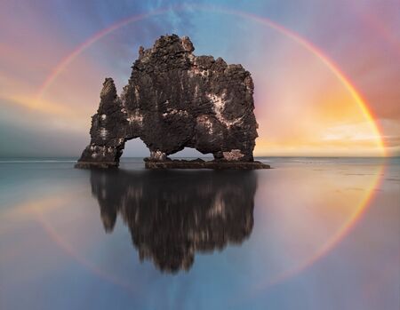 Colorful Rainbow over a ocean rock, Icelandの写真素材