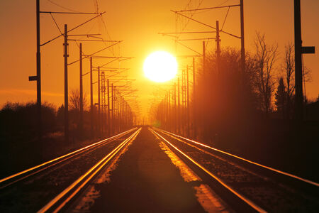 Railroad - Railway at sunset with sunの写真素材