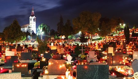 Cemetery at night with many graves and churchの写真素材