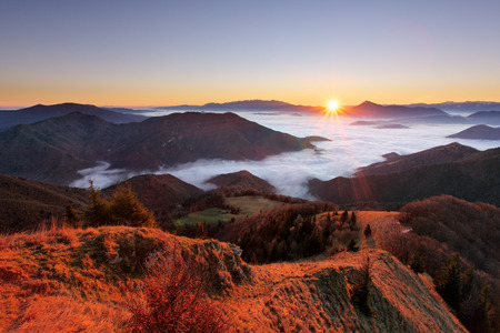 Mountain autumn landscape at sunrise with mist in Slovakiaの写真素材