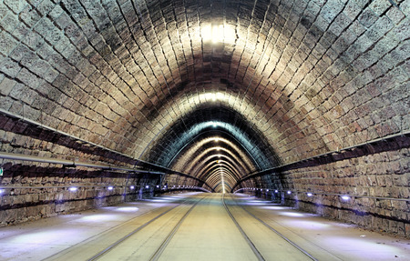 Tunnel with railroad and tramの写真素材