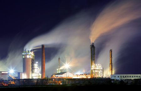 Oil refinery with vapor - petrochemical industry at nightのeditorial素材