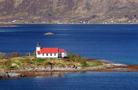 Church in fjord on Lofoten islands in Norwayの写真素材