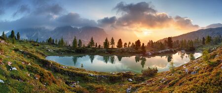 Mountain alps lake sunset panorama in Dolomitesの写真素材