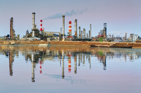 Oil refinery at night with reflection in waterのeditorial素材