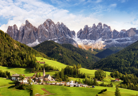 Val di Funes, Trentino Alto Adige, Italy. The great autumnal colors shines under the late sun with Odle on the background and Santa Magdalena Village on the foreground.の写真素材