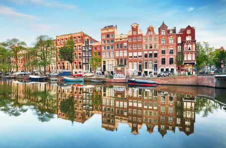 Canal houses of Amsterdam at dusk with vibrant reflections, Netherlandsの写真素材